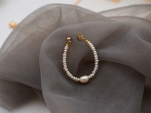 Detail of mini white freshwater pearls and baroque pearl drop with golden hook