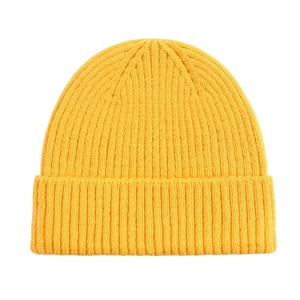 Close-up of bright yellow beanie showing the high-quality ribbed knit texture and soft yarn