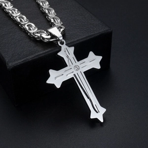 Detailed macro view of silver Byzantine chain with diamond-studded cross pendant for men
