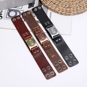 Detailed view of Viking tree leather bracelets with snap buttons and metal ornaments