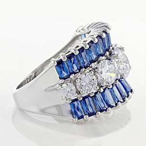 Detailed macro view of silver band with three rows of blue and white zircon stones