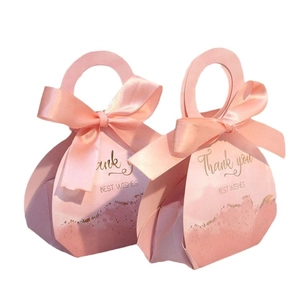 Set of two pink paper wedding gift boxes with ribbon bows and gold Thank You lettering
