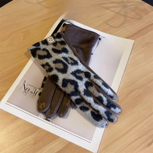 Detail of leopard print suede winter gloves with touch screen floral embroidery on finger