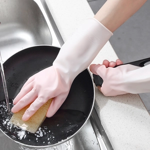 Pink waterproof latex gloves for housework, cleaning pans in a kitchen sink with water