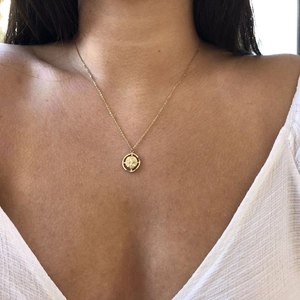 18K gold plated stainless steel necklace with a compass star pendant on a model