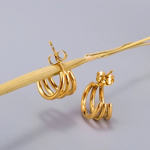 Macro shot of 18K gold plated three-layer curved stud earrings with butterfly backs