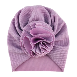 Detailed view of light purple baby turban hat featuring a 3D sunflower and textured fabric