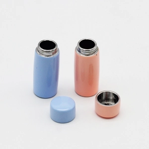 Detailed view of miniature blue and pink dollhouse thermos cups with removable lids