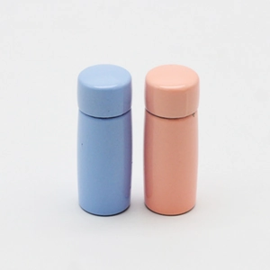 Detail of 1:12 dollhouse miniature thermal mugs in blue and pink with opening lids