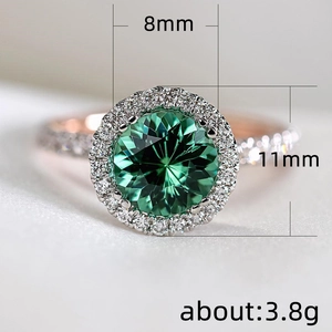 8mm round green emerald ring in rose gold halo setting with white cubic zirconia stones