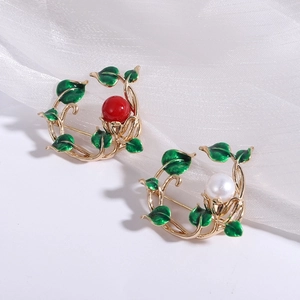 Fashionable botanical wreath brooches with red beads and white pearls on white silk