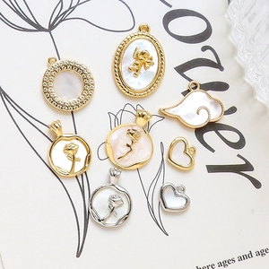 Golden and silver mother of pearl charms in heart, angel, and rose shapes for DIY jewelry
