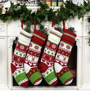 Detail of red and white knit Christmas stockings with snowflake patterns on fireplace