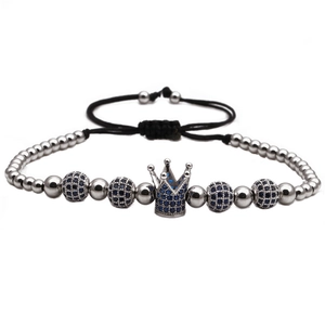 Detail of adjustable woven bracelet with blue zircon crown and silver metal beads