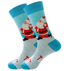 Detailed view of light blue Christmas socks with Santa Claus, snowman and snowflake patterns