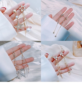Detail shot of four elegant long tassel earrings with silver needles and crystals