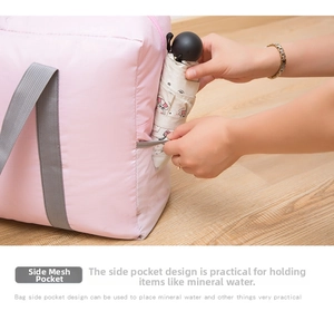 Pink travel bag detail showing side mesh pocket for storing a foldable umbrella