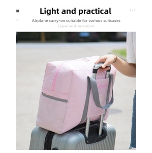 Pink travel duffel bag with luggage sleeve securely fixed on suitcase trolley handle
