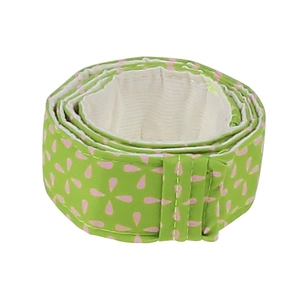 Detail view of a green bake even strip with pink floral pattern for cake pans