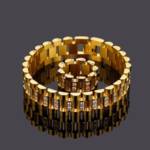 Macro shot of gold watch-band style ring and bracelet set with sparkling zircon crystals