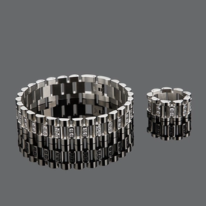 Close-up of silver watchband style bracelet and ring set with crystal inlay on black mirror