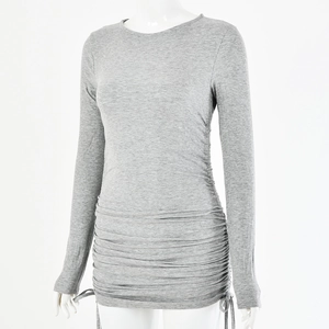 Close-up detail of grey ribbed knit texture and side drawstring ruched dress design