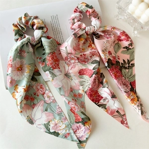 Floral satin scrunchies with long ribbons in mint green and pink colors for women