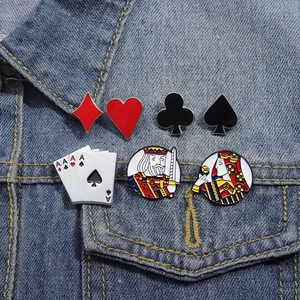 Set of 7 poker card enamel pins featuring Ace, King, and Queen motifs on denim jacket