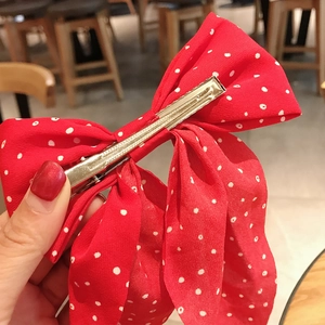 Red bow hair clip with white polka dots and durable silver metal duckbill clip
