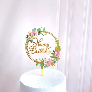 Golden Happy Birthday acrylic cake topper with pink floral and green leaf design