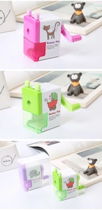 Manual rotary pencil sharpener in pink, green and purple colors with cartoon patterns