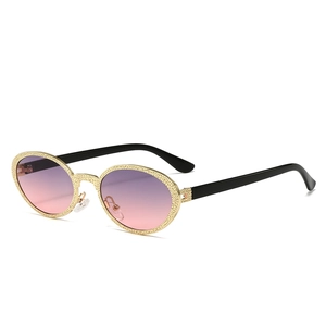 Vintage oval metal sunglasses with gold textured frames and gradient purple pink lenses