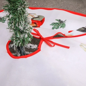 White Christmas tree skirt with festive red bow ties and colorful cartoon character prints