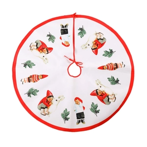 White Christmas tree skirt with red border and festive dolls for holiday tree decoration