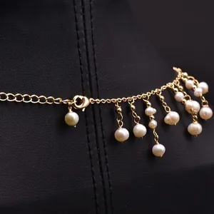 Elegant handmade freshwater pearl tassel necklace with gold chain on jewelry display stand