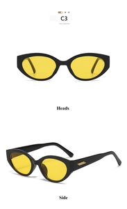 Détail de lunettes de soleil œil de chat avec monture noire et verres teintés jaunes