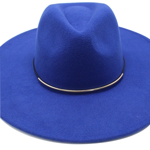 Close-up of royal blue wide brim fedora hat featuring a gold metal ring buckle detail