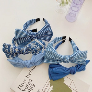 Detail of assorted blue denim fabric headbands with bow ties in stripe and floral patterns