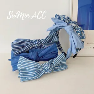 Set of four blue denim fabric headbands with double-layer bows and striped floral patterns