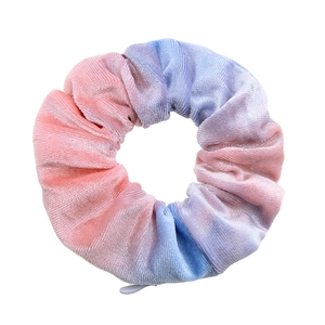 Close-up of pink, blue, and purple tie-dye velvet hair scrunchie with hidden zipper
