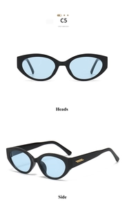 Détail de lunettes œil de chat noires avec verres bleus et finitions métalliques dorées aux branches