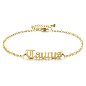 Close-up of golden stainless steel Taurus pendant anklet with gothic font and lobster clasp