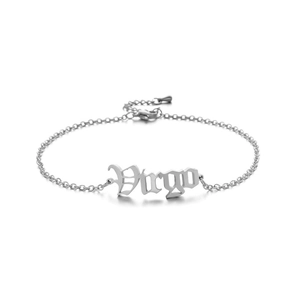 Detailed macro view of the silver stainless steel Virgo zodiac pendant on an anklet chain