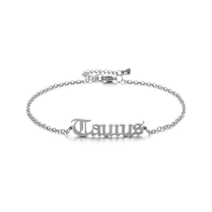 Macro detail of silver-tone stainless steel chain anklet with Taurus zodiac pendant