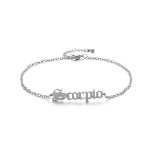 Detail of silver Scorpio anklet with gothic lettering and lobster clasp on white background