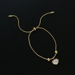 Golden titanium heart bracelet with white mother of pearl inlay and adjustable twist chain