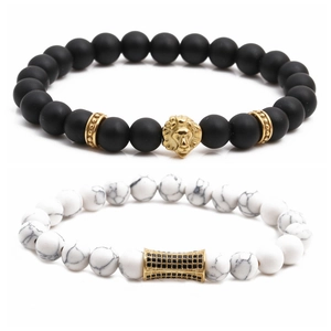 Matte black and white marble bead bracelet set with golden lion head and charm