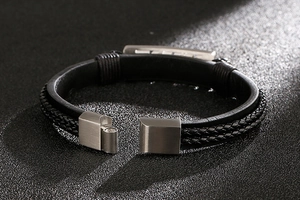 Macro view of multi-layer black leather bracelet with brushed metal magnetic clasp