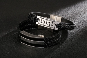 Detail of woven leather men's bracelets with patterned stainless steel magnetic clasps