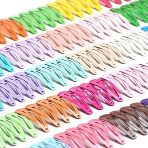 Bulk set of colorful 5cm matte metal snap hair clips for kids in a neat rows display